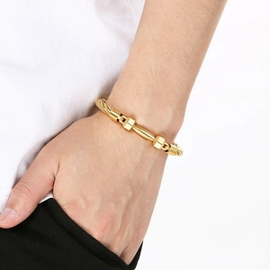 Men's golden stainless steel barbell wire rope bracelet on male model wrist