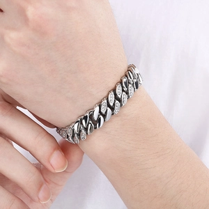 Detailed close-up of 12mm silver cuban link bracelet with sparkling diamond accents