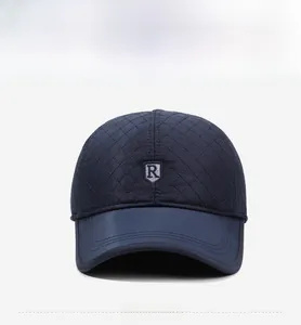 Front view of quilted baseball cap featuring diamond stitching and shield letter R embroidery