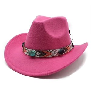 Detail of pink felt cowboy hat featuring ethnic embroidered band and turquoise stone