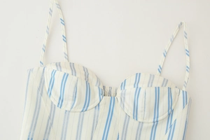 Detail of blue and white striped bustier top with thin straps and ruffled cups