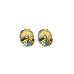 Vintage gold-framed enamel earrings with floral patterns and pearl accents on white background