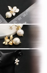 Detailed view of 18K gold plated four-petal flower earrings with fresh water pearls
