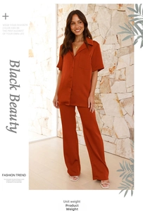 Detailed close-up of terracotta satin short sleeve lounge top and wide leg pants set