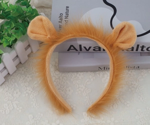 Detailed close-up of brown plush lion ears headband on a decorative lace background