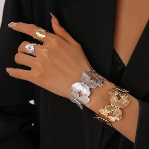 Two-piece set of gold and silver butterfly open bracelets and matching rings for women