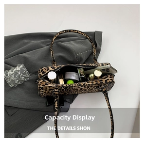 Detail view of the spacious interior of a leopard print bag with daily essentials