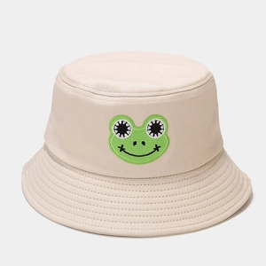 Detailed close-up of a beige cotton bucket hat with a cute green frog embroidery