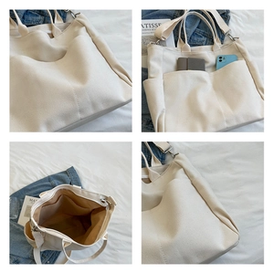 Detail view of large canvas tote bag with multiple pockets and adjustable strap