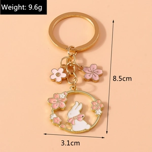 Detail view of rabbit and cherry blossom keychain with size and weight measurements