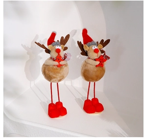 Detailed view of plush reindeer Christmas figures with red hats and scarves in white alcove