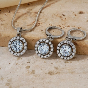Detailed close-up of a silver jewelry set featuring a necklace and matching round earrings
