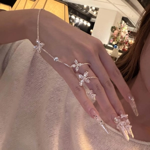 Elegant French style silver hand chain featuring zircon flowers and integrated ring detail