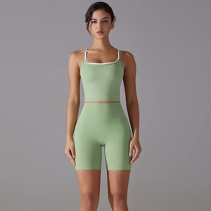 Detail of light green seamless yoga set with U-neck sports bra and high waist biker shorts