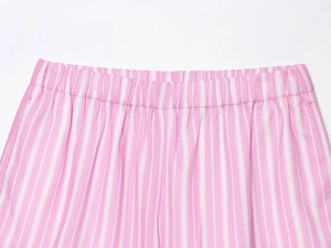 Detailed close-up of elastic waistband on pink and white striped woven shorts