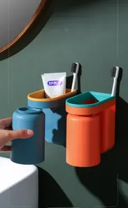 Detail of wall-mounted toothbrush holder with inverted drainage cups in blue and orange