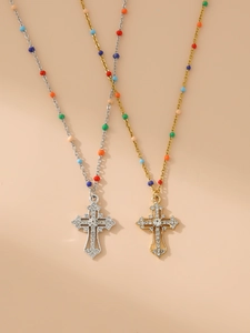 Detailed view of colorful beaded cross pendants with sparkling rhinestones in gold and silver