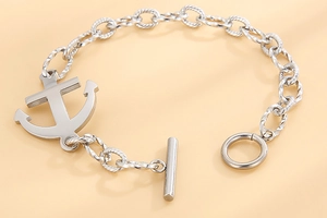 Macro view of silver anchor pendant and vintage T-bar toggle clasp on a twisted chain