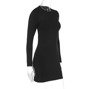Detail view of the sleek backless design and slim fit cut on a black mini dress