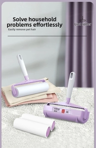 Detail view of purple lint roller set with two handles and two white refill rolls