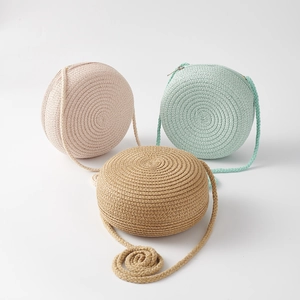 Detailed set of cute children's straw bags in pink, mint green and khaki for summer