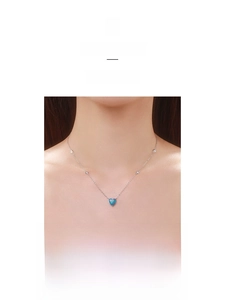 Detail of S925 sterling silver heart opal necklace with sparkling zircon on model