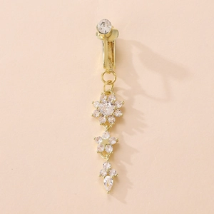 Elegant gold belly piercing with sparkling snowflake crystals in a vertical floral design