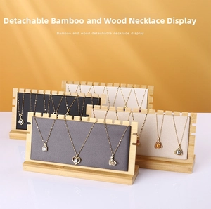 Close-up of bamboo necklace display stand with multiple color options and serrated top slots