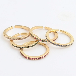 Detailed view of five adjustable gold rings with micro-set multi-colored cubic zirconia