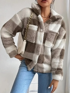 Close-up of brown plaid teddy jacket featuring warm lamb wool texture and classic buttons