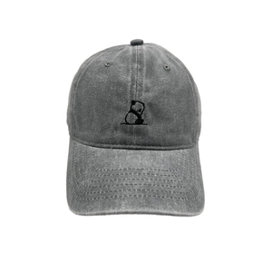 Close-up of grey washed cotton baseball cap with panda embroidery and vintage texture