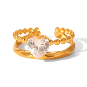 Close-up of heart-shaped diamond ring with gold beaded band and twisted rope texture