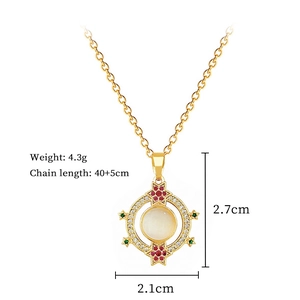 Detailed view of a gold-tone necklace with a cat-eye stone pendant and small gems