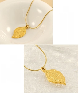 Detailed macro view of gold-plated leaf pendant necklace with lead-free certification