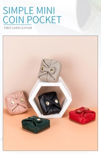 Flat lay of small leather coin purses in various colors on a peach background