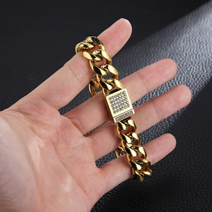 Detail of gold Cuban link bracelet featuring a square clasp encrusted with clear zircons