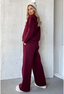 Detail of burgundy lounge set featuring heart print sweatshirt and wide-leg joggers