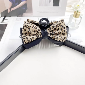 Large leopard print bow hair claw clip for elegant updo hairstyles in black and tan
