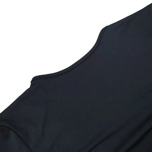 Close-up of the smooth black fabric and precision stitching on the crew neck collar