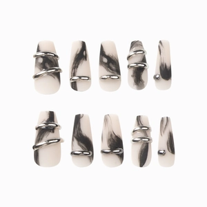 Matte black marble press-on nails with silver metallic accents in mid-length coffin shape
