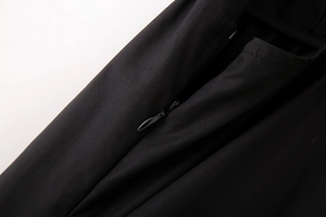 Vue détaillée de la fermeture éclair invisible sur une robe midi noire en coton