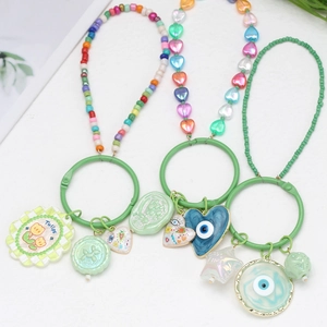 Detailed macro view of colorful beaded evil eye phone charms with luck and tulip charms