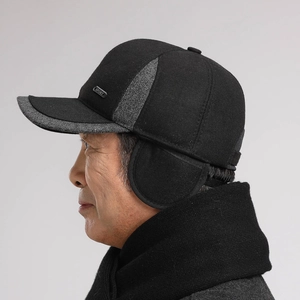 Detail view of winter baseball cap with ear flaps and wool texture for elderly men