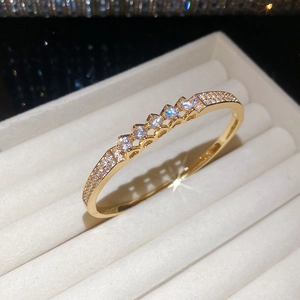 Macro shot of gold-plated bracelet featuring five diamond-encrusted lozenge frames