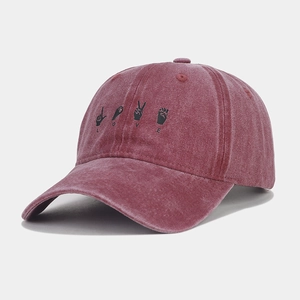 Detailed shot of burgundy washed cotton baseball cap with LOVE hand signs and distressed brim