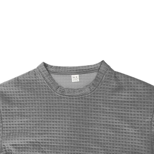 Close-up of gray waffle knit crew neck collar and care label on men's sports set