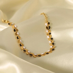 18K gold plated stainless steel heart bracelet with black and white enamel charms