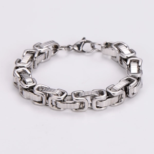 Macro detail of high-polish square link stainless steel men's bracelet with lobster clasp