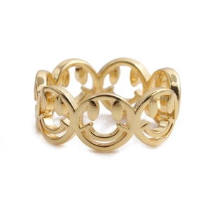 Detailed view of polished golden smile face hollowed-out ring made of premium copper