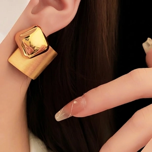 Minimalist geometric gold earrings with mixed mirror and brushed metal textures